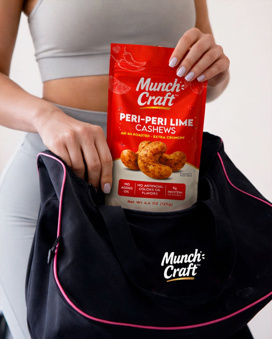 Person pulling a Munch Craft Peri-Peri Lime Cashews pouch from a gym bag