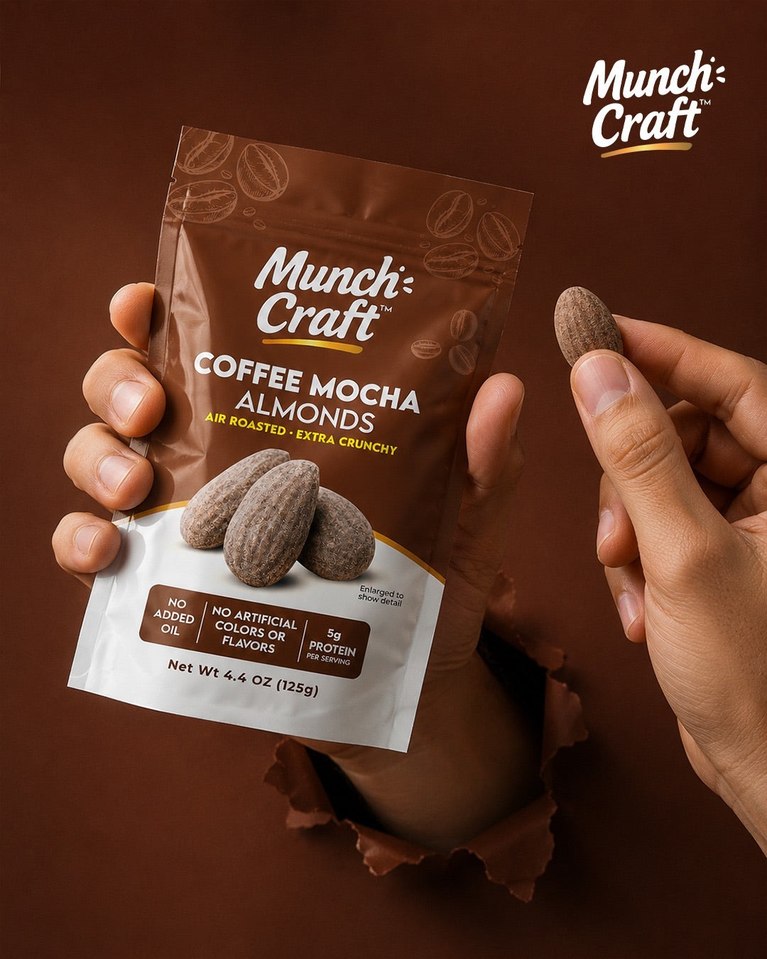 Hand holding a Munch Craft Coffee Mocha Almonds pouch and an almond, close up